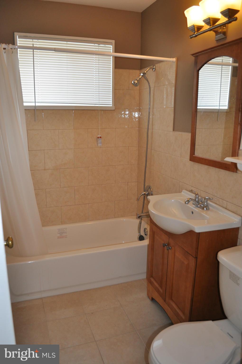 1108 Navahoe Drive Silver Spring, MD 20903 - Photo 11 of 14 a bathroom with a sink a toilet and shower