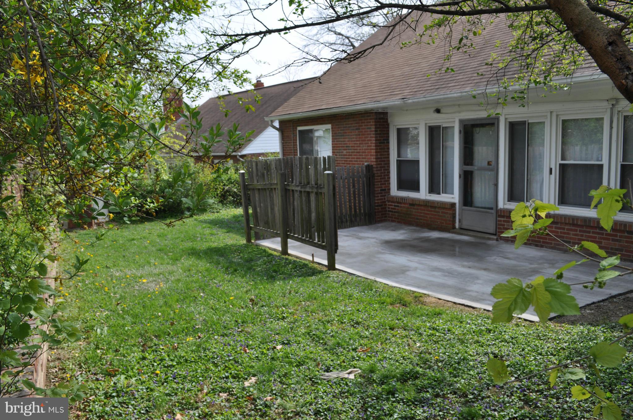 1108 Navahoe Drive Silver Spring, MD 20903 - Photo 3 of 14 a view of a house with brick walls and a yard with plants