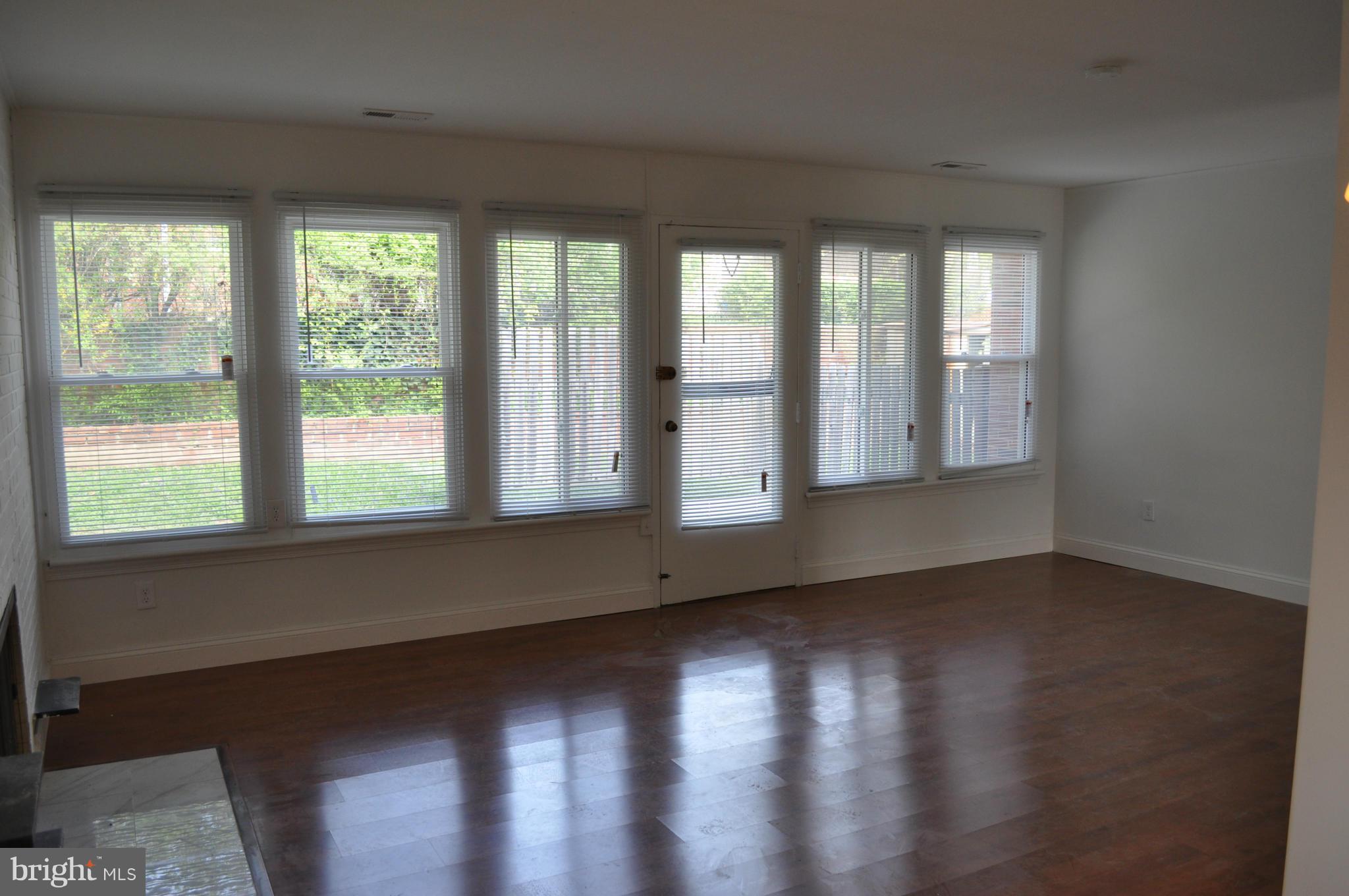 1108 Navahoe Drive Silver Spring, MD 20903 - Photo 4 of 14 a view of an empty room with wooden floor and a window