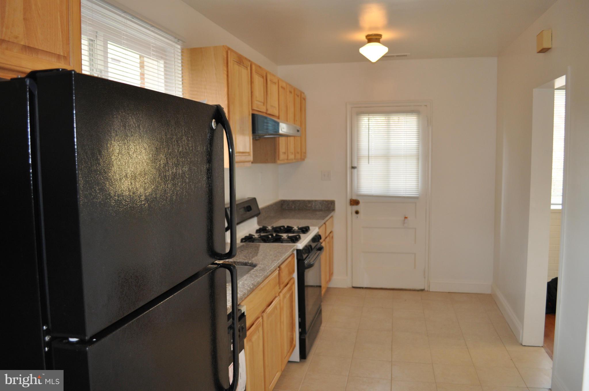 1108 Navahoe Drive Silver Spring, MD 20903 - Photo 9 of 14 a kitchen with a refrigerator and a stove