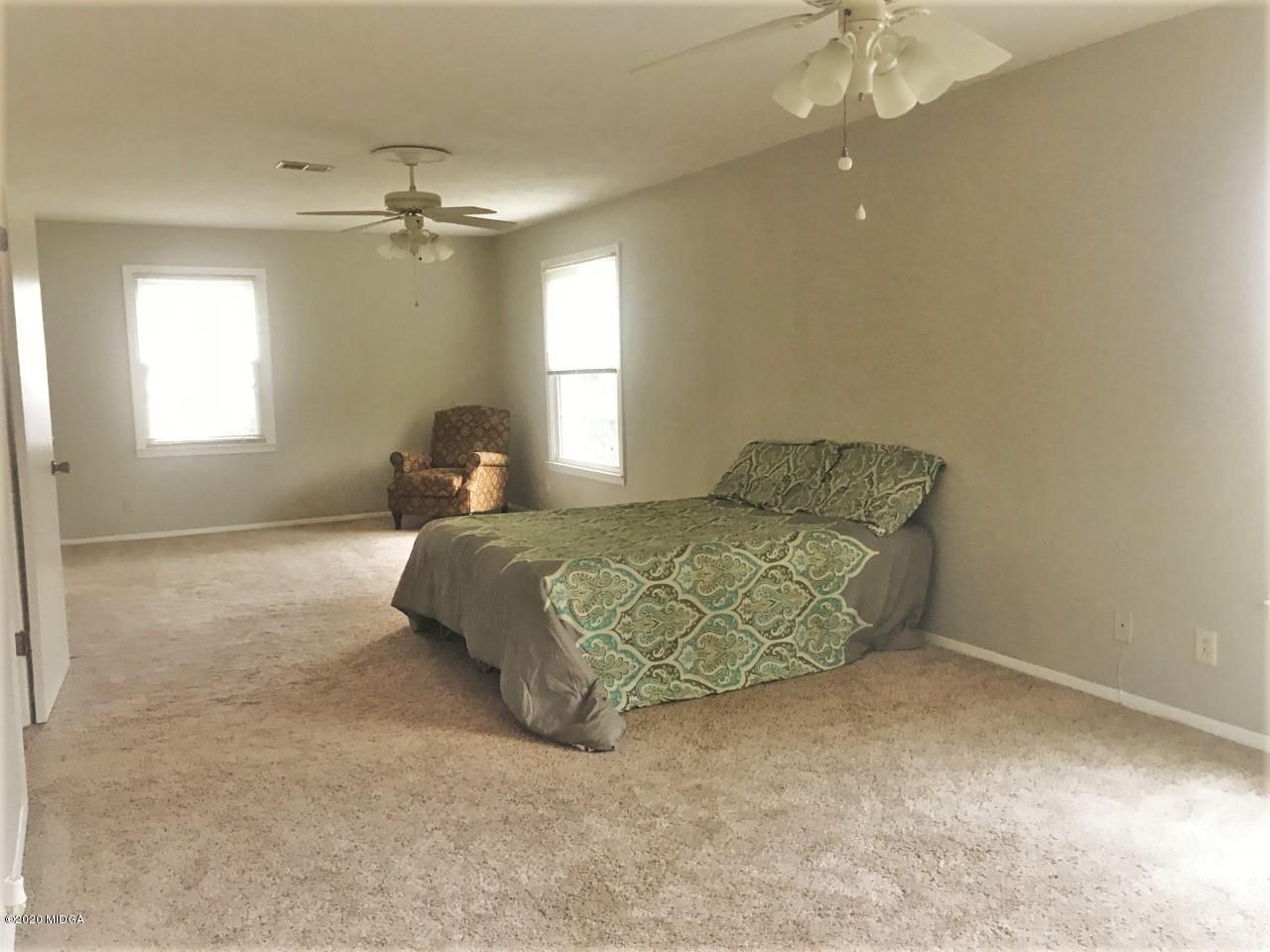 6669 Goodall Mill Road Macon, GA 31216 - Photo 15 of 28 a bedroom with a bed and window