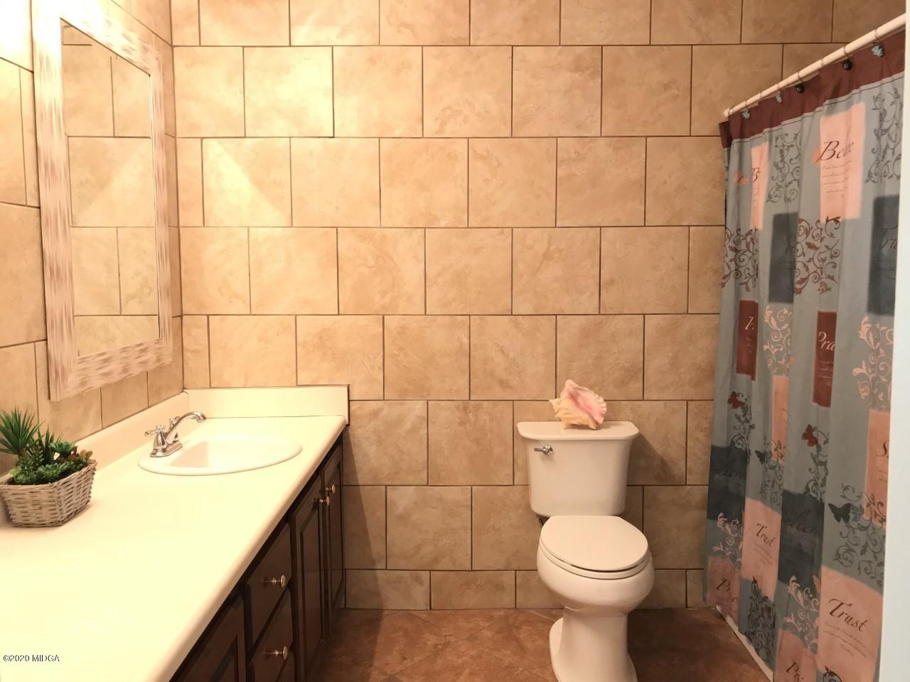 6669 Goodall Mill Road Macon, GA 31216 - Photo 18 of 28 a bathroom with a sink toilet and shower