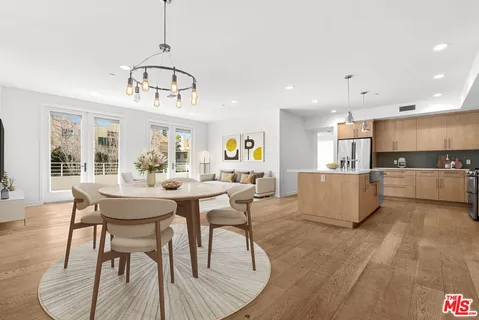 a view of a dining room with furniture window and wooden floor