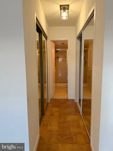 a view of a hallway with wooden floor