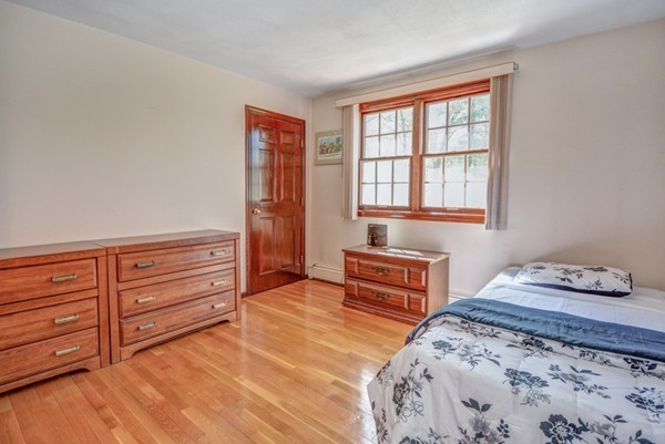 312 Depot Road Boxborough, MA 01719 - Photo 21 of 30 a bedroom with a bed and wooden floor