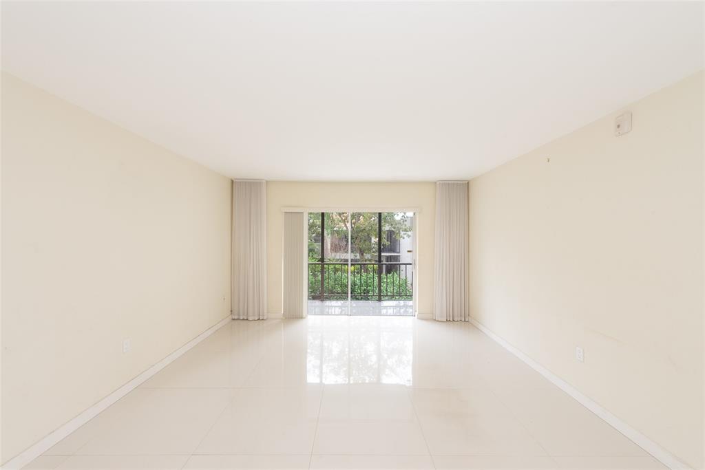 7925 Southwest 104th Street, Unit 203E Miami, FL 33156 - Photo 12 of 23 a view of an empty room with a window