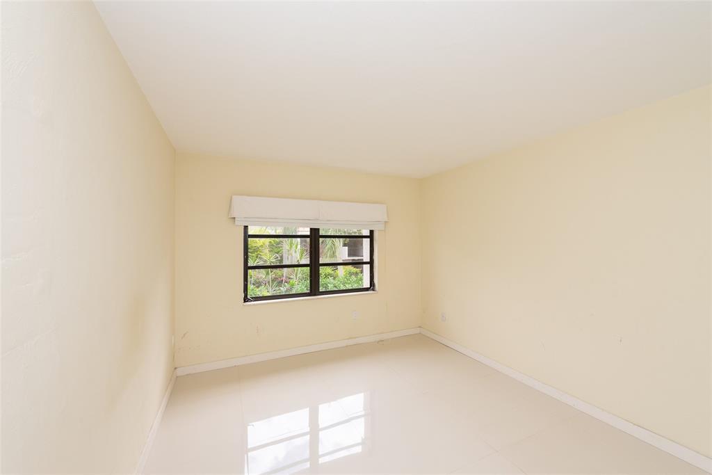 7925 Southwest 104th Street, Unit 203E Miami, FL 33156 - Photo 13 of 23 an empty room with a window