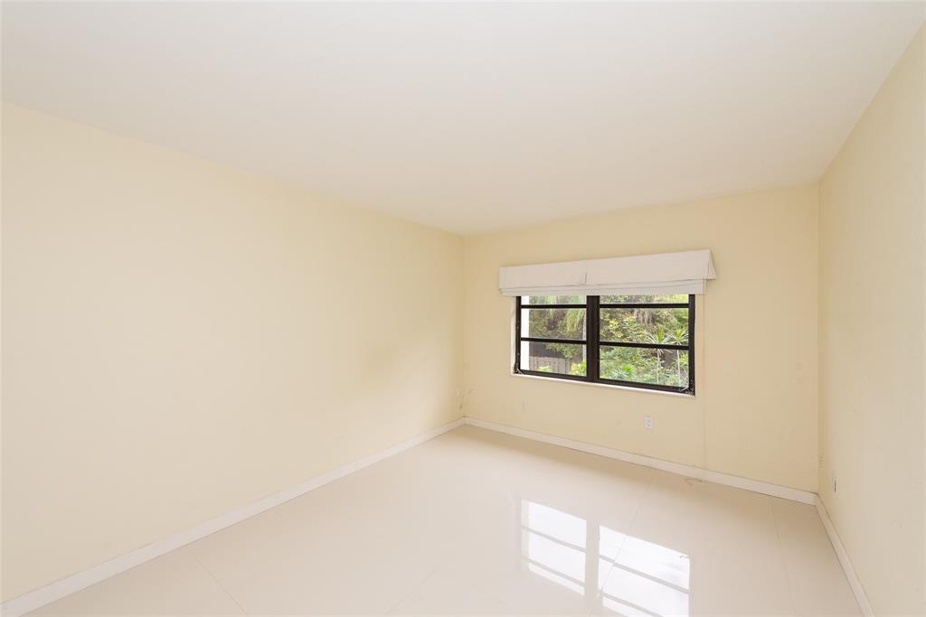 7925 Southwest 104th Street, Unit 203E Miami, FL 33156 - Photo 14 of 23 an empty room with windows and closet