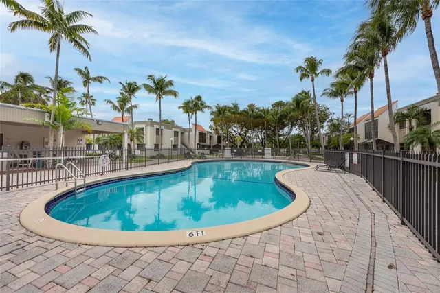a view of swimming pool with outdoor seating and plants