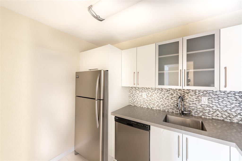 7925 Southwest 104th Street, Unit 203E Miami, FL 33156 - Photo 6 of 23 a kitchen with a sink and refrigerator