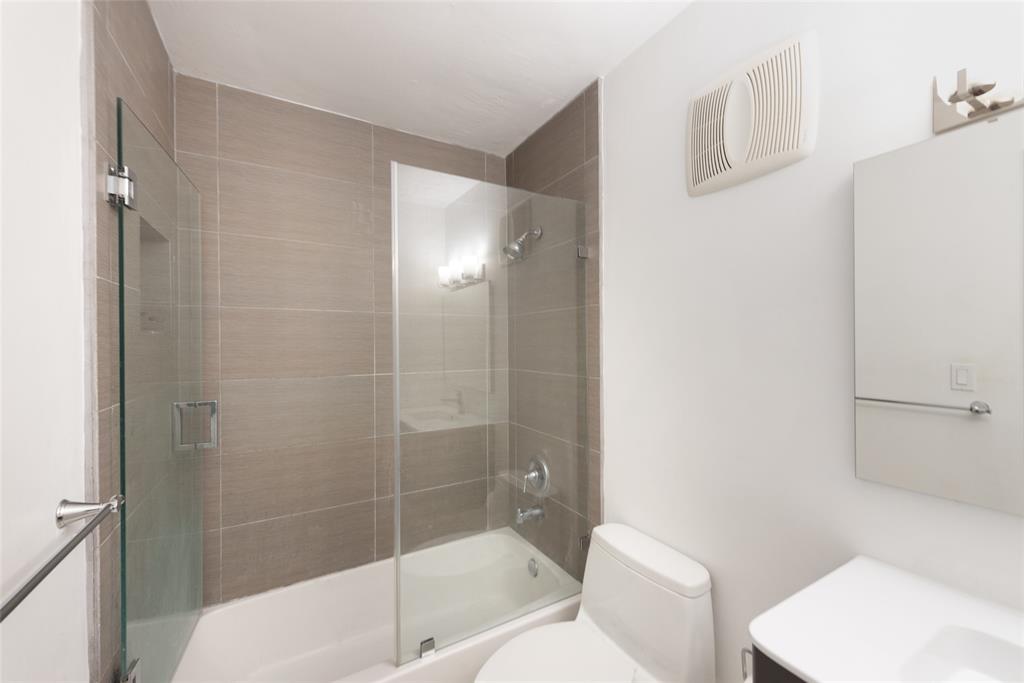 7925 Southwest 104th Street, Unit 203E Miami, FL 33156 - Photo 9 of 23 a bathroom with a toilet and shower