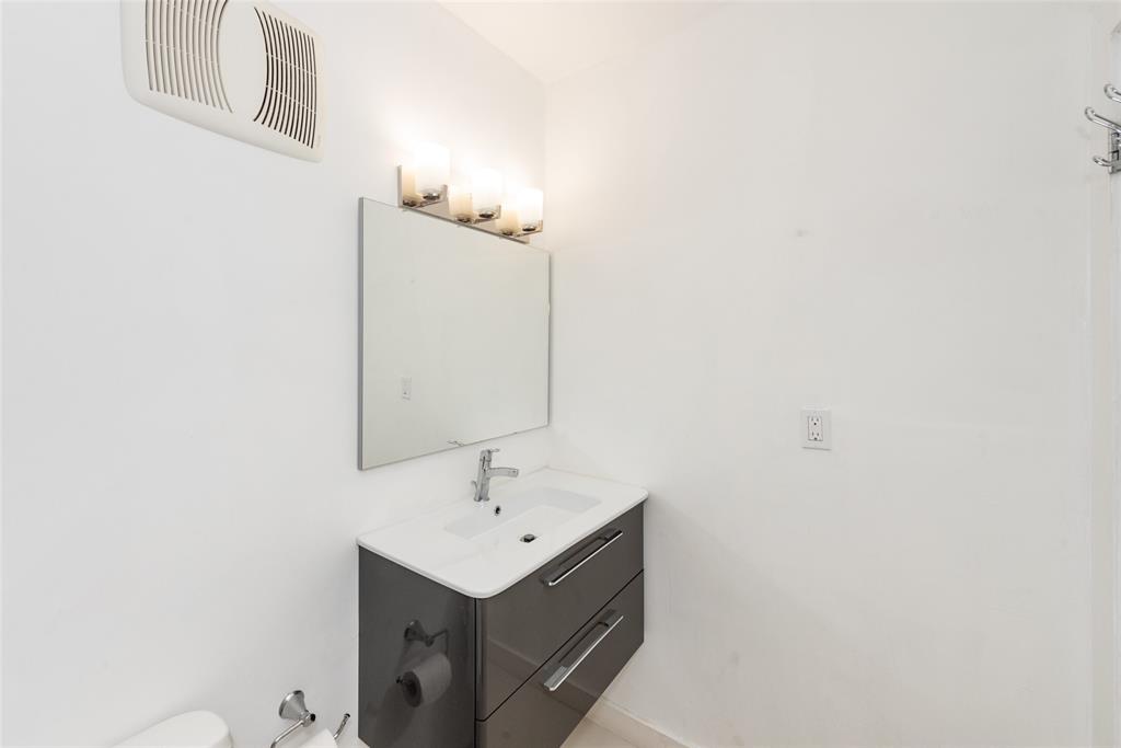 7925 Southwest 104th Street, Unit 203E Miami, FL 33156 - Photo 10 of 23 a bathroom with a sink and a mirror