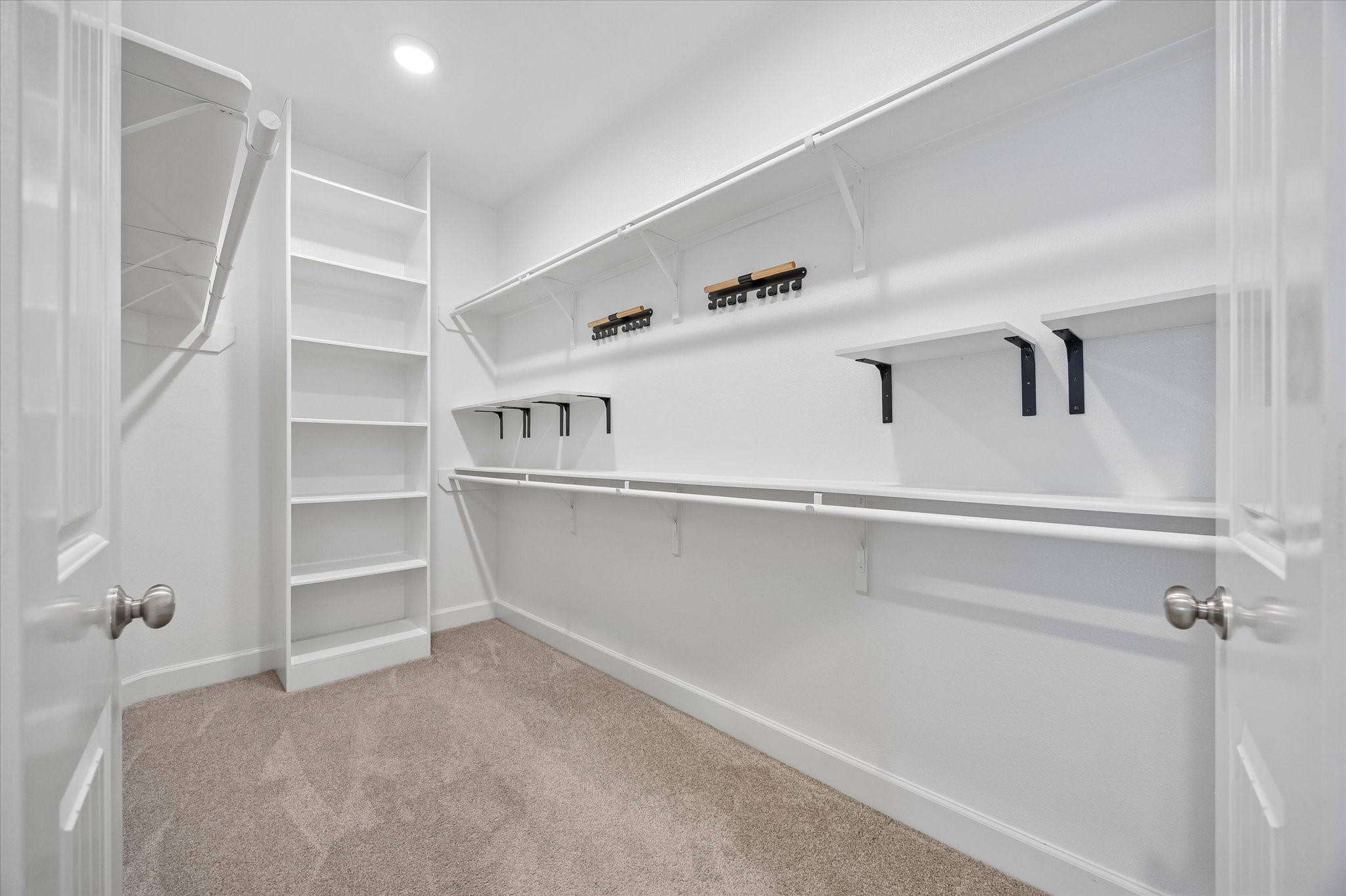 809 Malone Street Houston, TX 77007 - Photo 24 of 26 Spacious primary walk-in closet with extensive built-in shelving and storage.