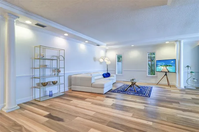 a living room with furniture and a book shelf