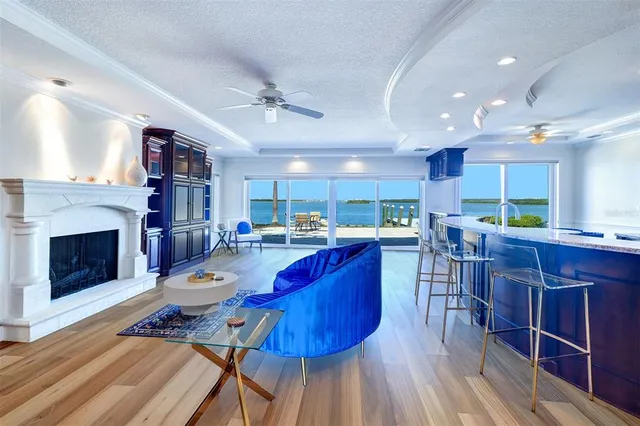 a living room with furniture a fireplace and a kitchen view