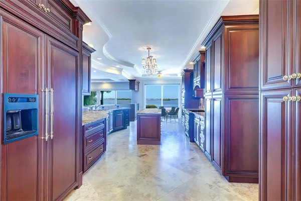 a view of kitchen with cabinets and window