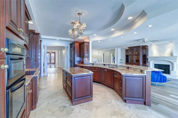 a large kitchen with stainless steel appliances granite countertop a large center island and a sink