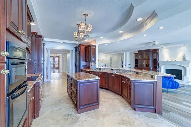 a large kitchen with stainless steel appliances granite countertop a large center island and a sink