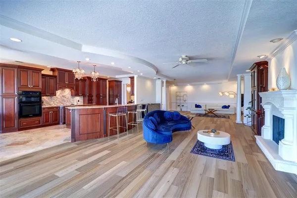 a living room with lots of furniture and kitchen view