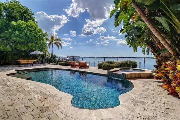 a view of swimming pool with outdoor seating and plants
