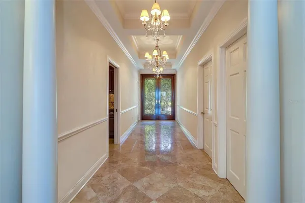 a view of a hallway with a chandelier