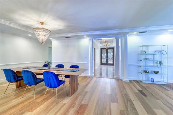 a dining room with furniture and wooden floor