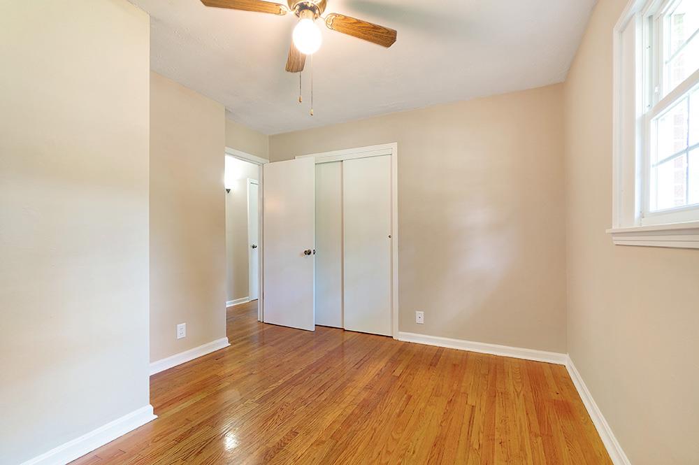 210 Pitt Lane Springfield, TN 37172 - Photo 21 of 27 an empty room with wooden floor chandelier fan and windows