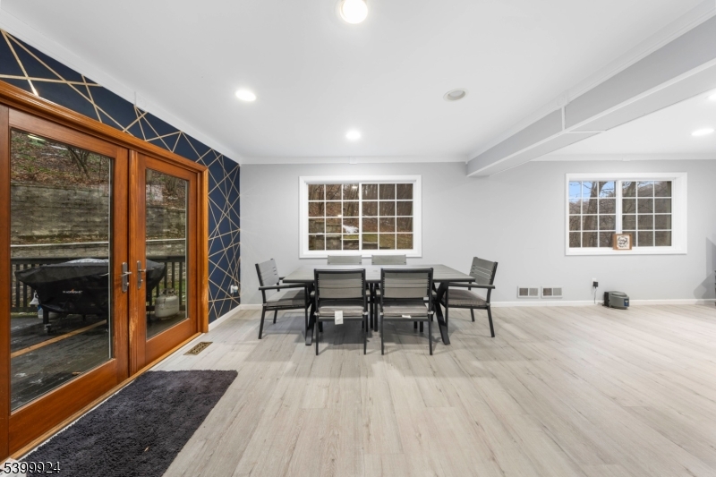 123 Vail Road Columbia, NJ 07832 - Photo 5 of 44 a dining room with wooden floor and a floor to ceiling window