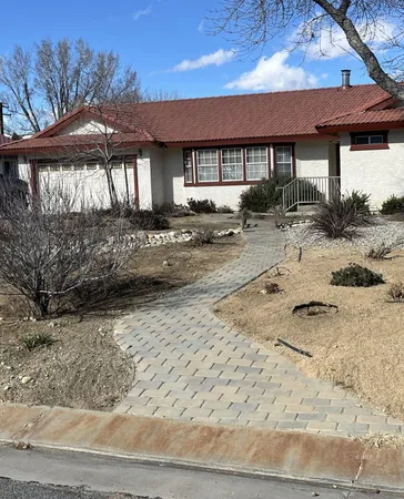 a view of a backyard with a patio and fire pit