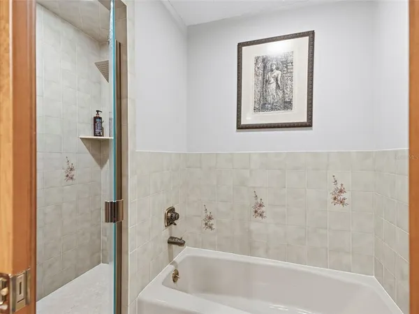 a bedroom with a bed a couch and a chandelier