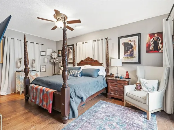 a room with a white house and wooden floor