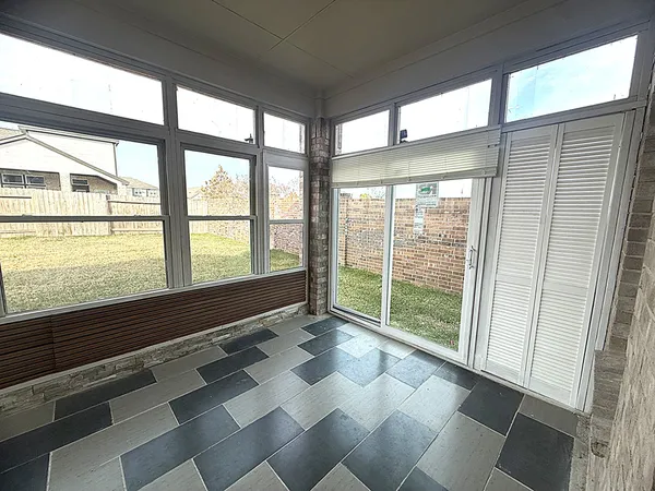 a view of an empty room with a large window