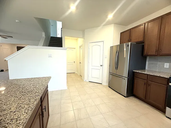 a kitchen with stainless steel appliances a refrigerator sink and microwave