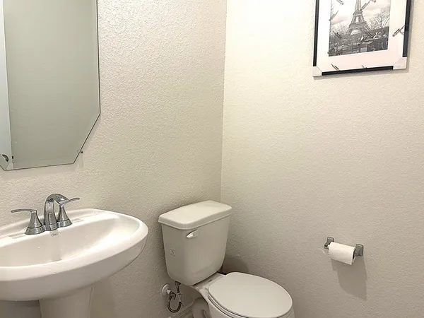 a white toilet sitting next to a white sink
