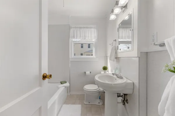 a bathroom with a sink toilet tub and shower