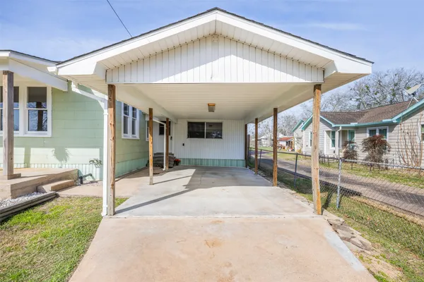 a view of a house with a porch and furniture