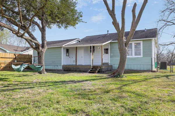 a view of a house with backyard porch and sitting area