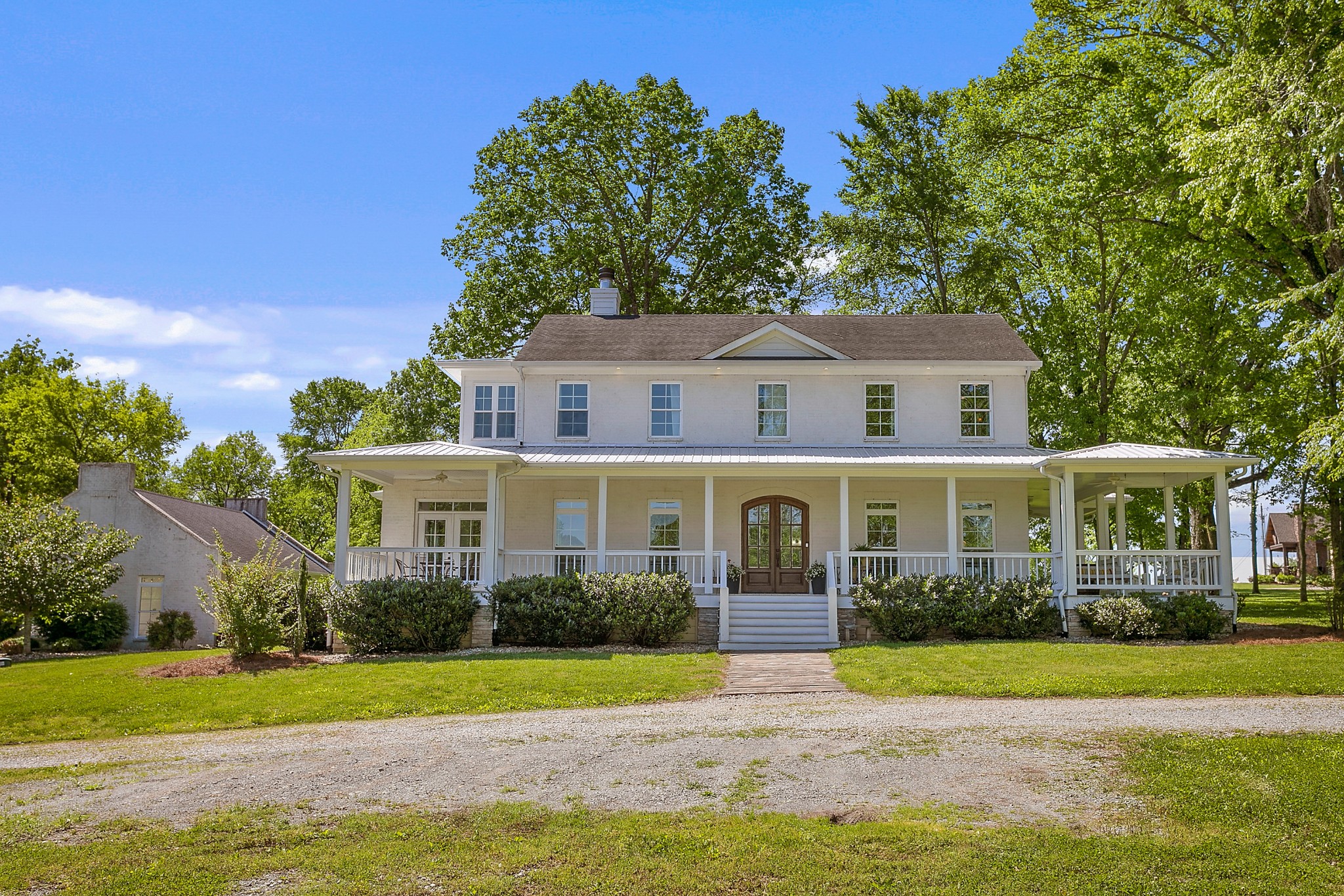 4280 Central Valley Road Murfreesboro, TN 37129 - Photo 2 of 50 Idyllically set on 5.29 acres, this home welcomes everyone with a true wrap-around porch. Snag a spot on the porch swing with a glass of Southern sweet iced tea, feel the cool breeze, & listen to the peaceful sounds of country living.