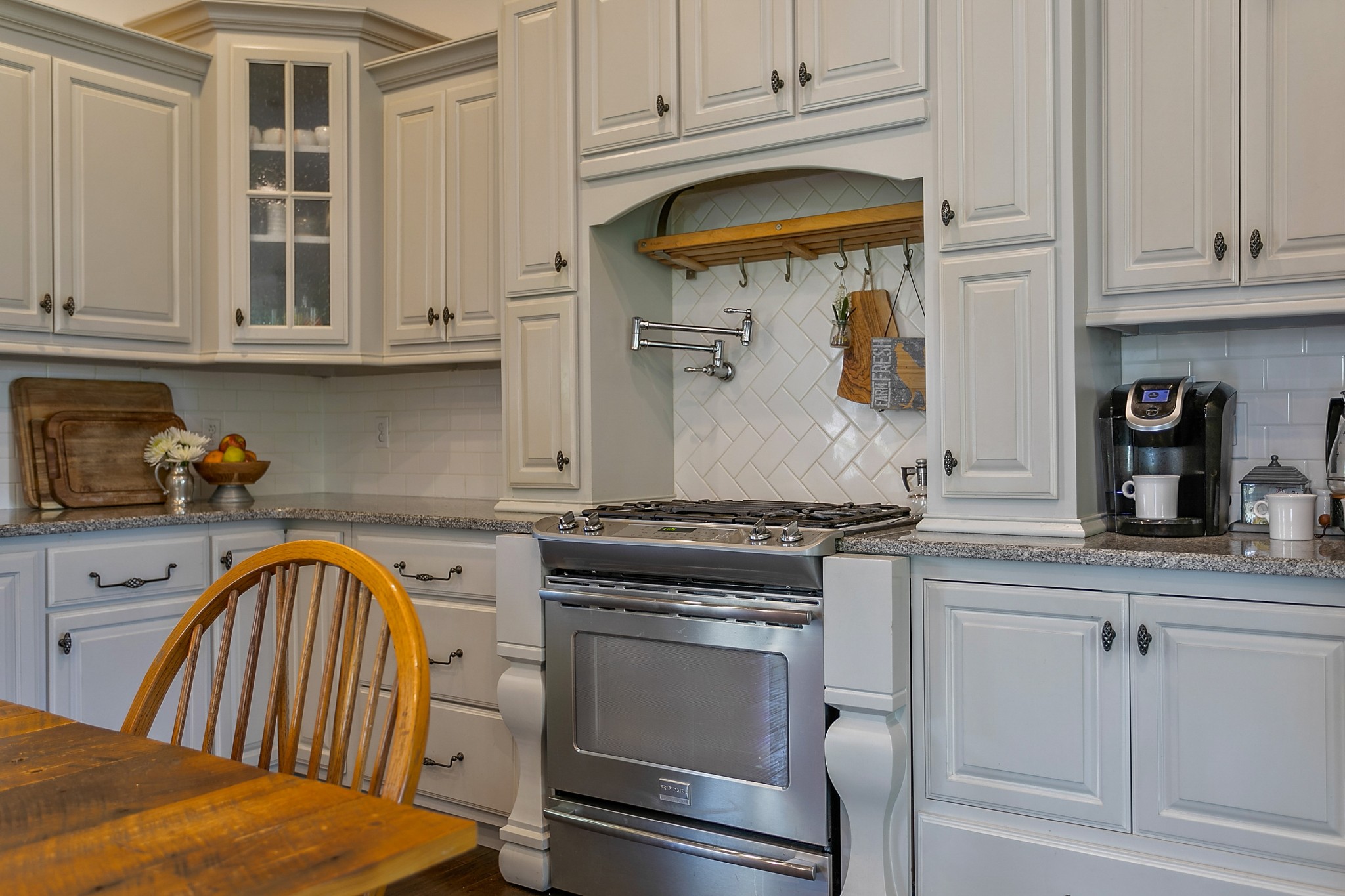 4280 Central Valley Road Murfreesboro, TN 37129 - Photo 20 of 50 Encased in decorative cabinetry is the stainless steel Frigidaire gas stove.