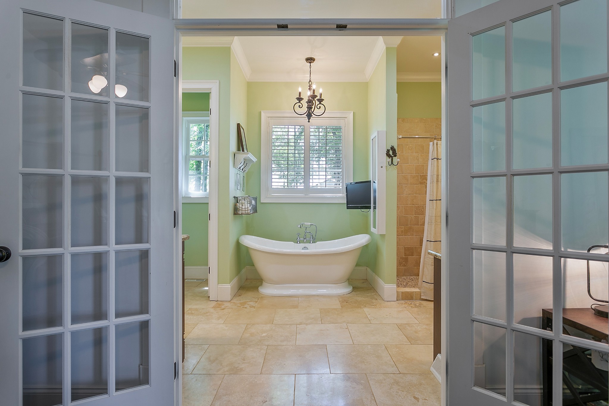 4280 Central Valley Road Murfreesboro, TN 37129 - Photo 26 of 50 The spacious owner's bathroom features tile floors and granite counters. A freestanding tub sits under a chandelier and features a tv hookup. The walk-in shower is generous and there is a separate toilet closet.