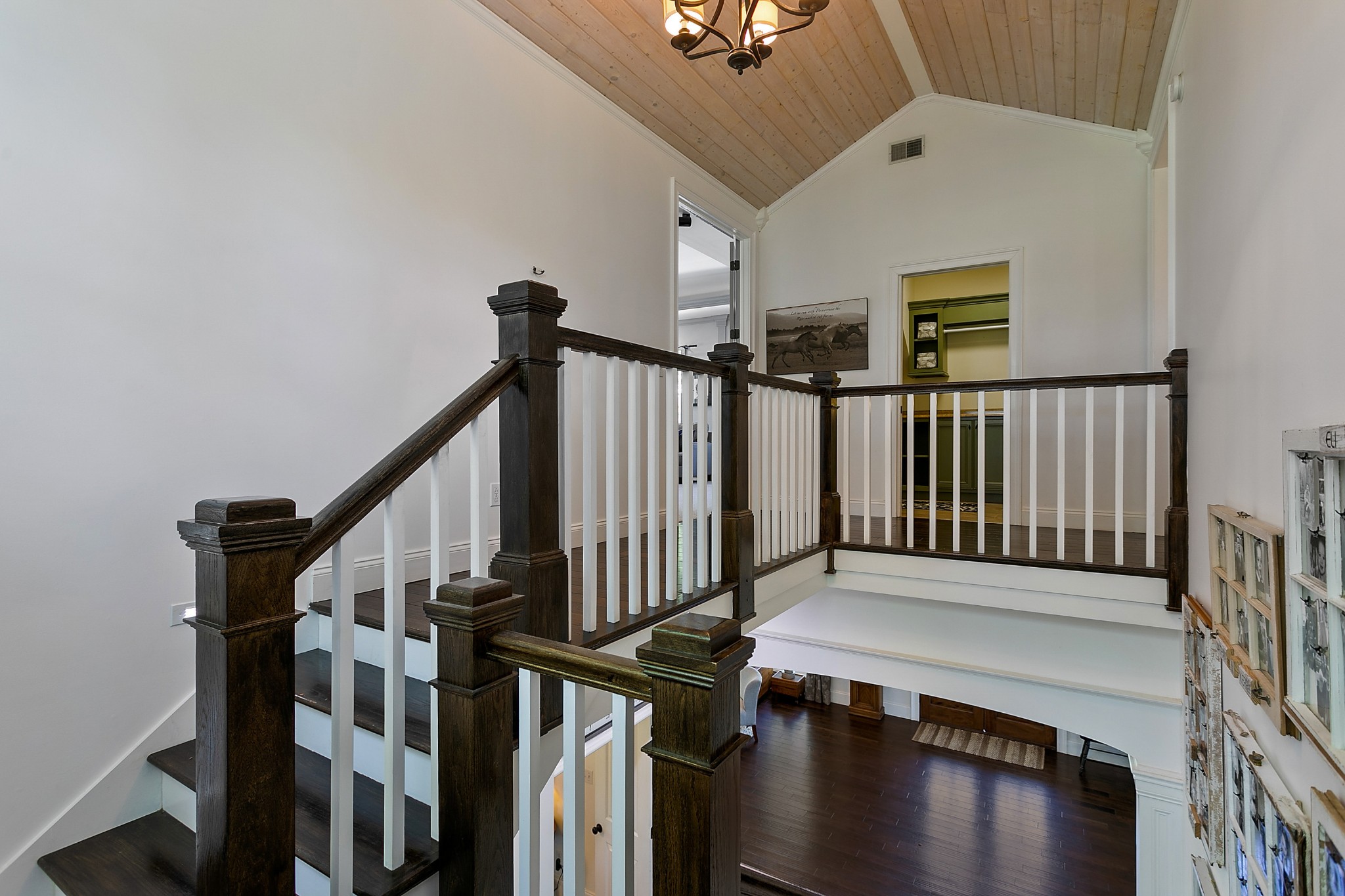 4280 Central Valley Road Murfreesboro, TN 37129 - Photo 29 of 50 Head up the hardwood stairs with matching tread, posts, and railing, with white balusters and risers. Overhead is a natural wood plank ceiling. Upstairs one can find the additional two bedrooms, second laundry room, and an impressive bonus room.