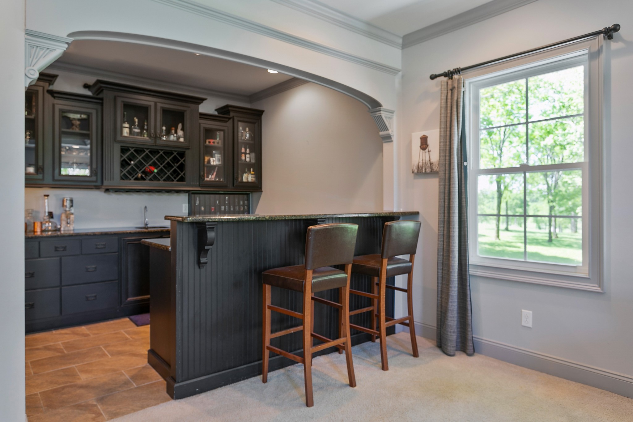 4280 Central Valley Road Murfreesboro, TN 37129 - Photo 32 of 50 Saddle on up to this great tiled bar area. Enjoy custom black cabinetry with glass fronts, a sink, wine fridge, and mini-fridge. Cocktails anyone? There is even a full bathroom designated for your movie guests.