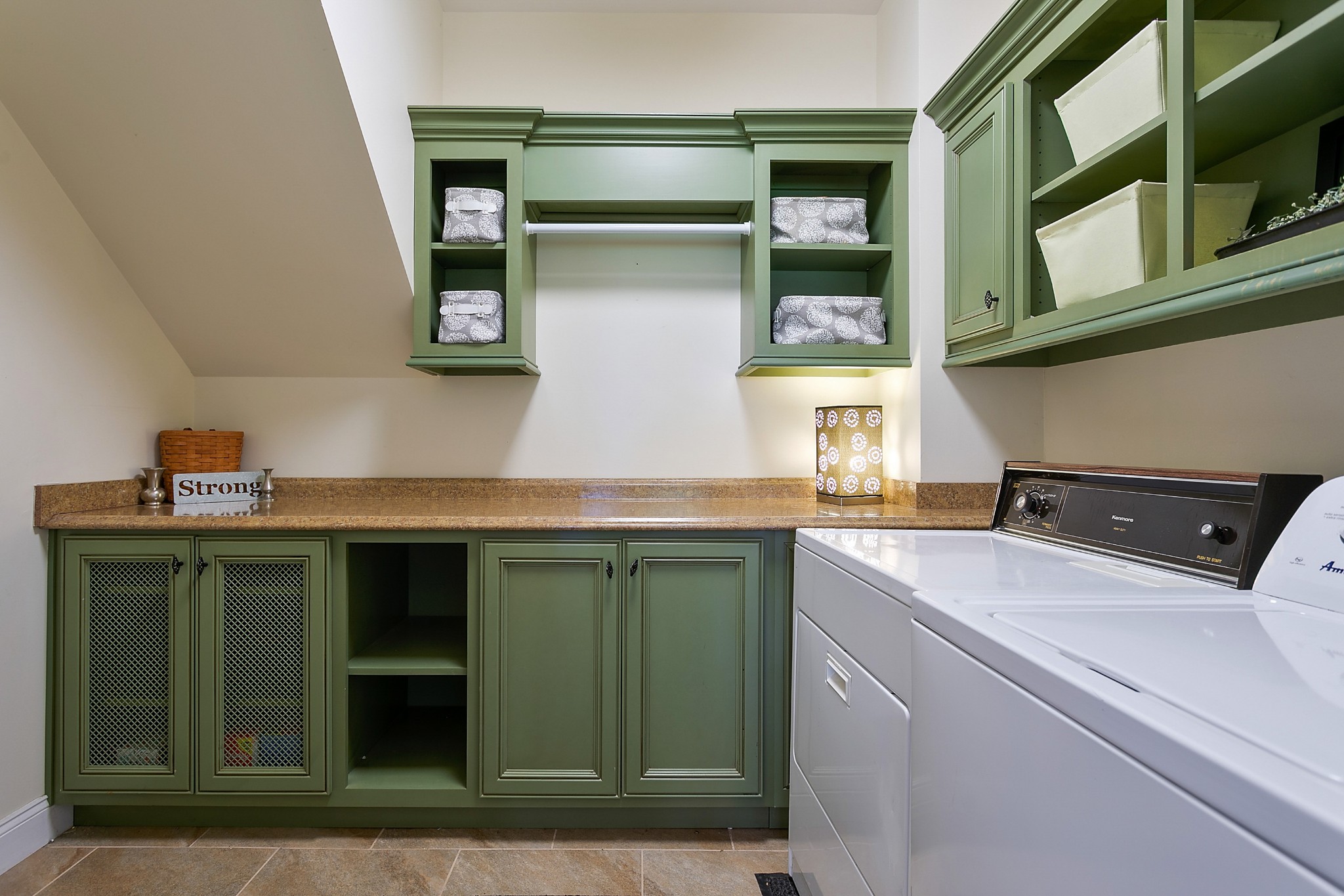 4280 Central Valley Road Murfreesboro, TN 37129 - Photo 34 of 50 This large laundry room is located upstairs and is host to charming moss green cabinetry with lovely details. With plenty of storage, there is also a hanging rack, granite counters, and durable tile flooring.