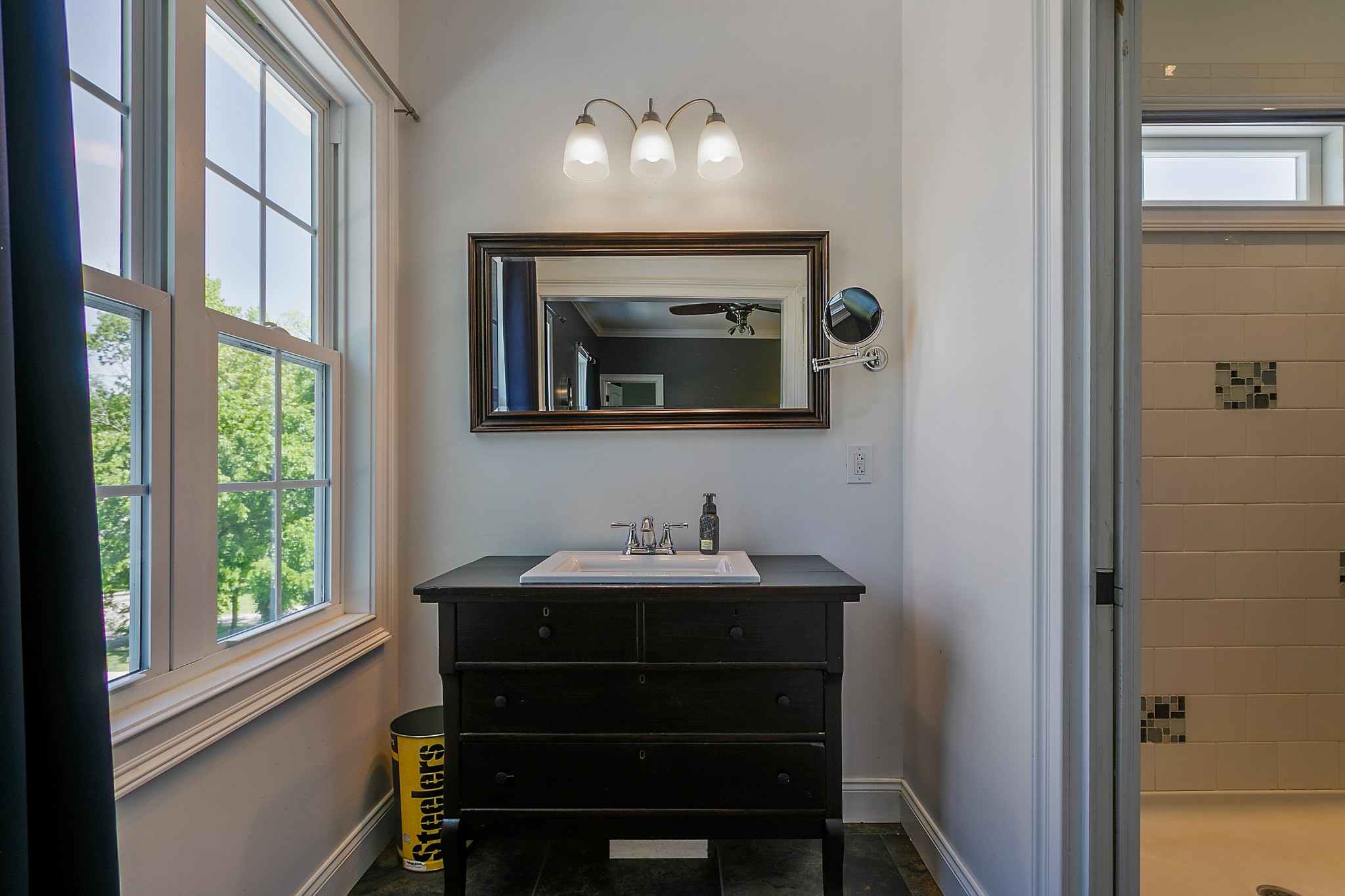 4280 Central Valley Road Murfreesboro, TN 37129 - Photo 36 of 50 This bathroom has a custom vanity piece and is separated from the tiled walk-in shower via a pocket door. Even with plenty of windows for natural light, there are light fixtures and recessed lights too.