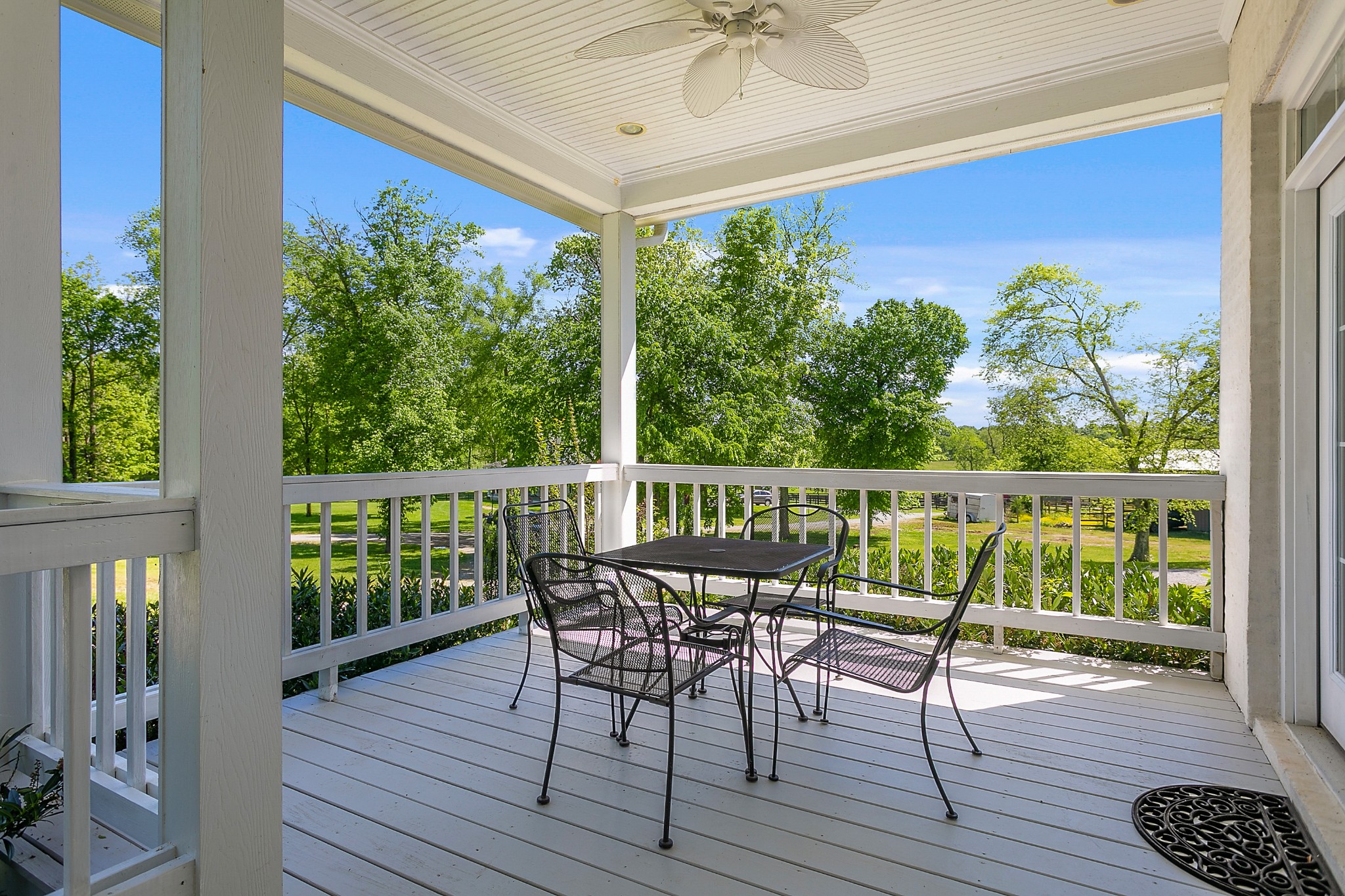 4280 Central Valley Road Murfreesboro, TN 37129 - Photo 8 of 50 Enjoy a relaxing meal on the porch overlooking the property. The porch floorboards have been painted a pale grey to compliment the white brick and white posts and railings.