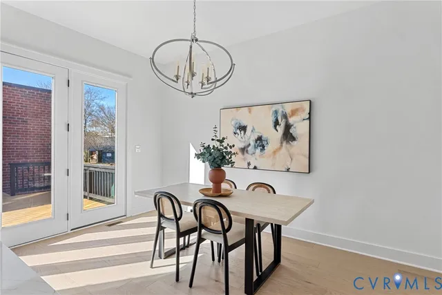 a view of a dining room with furniture wooden floor and chandelier