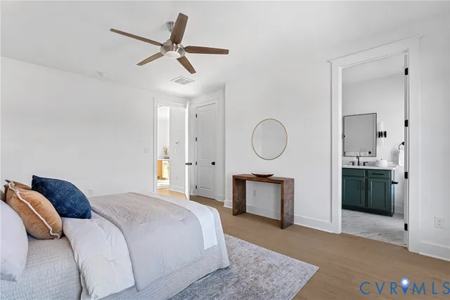 a bedroom with a bed a mirror and a chandelier