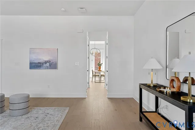 a kitchen with stainless steel appliances granite countertop a stove a sink and a refrigerator with wooden floor