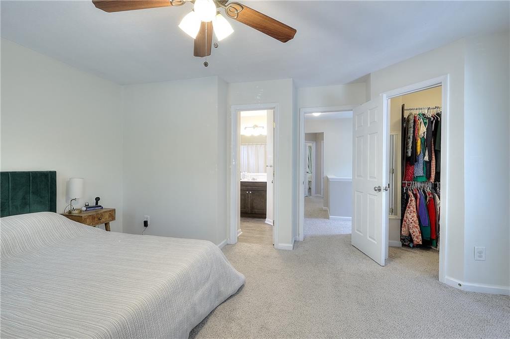 148 Alice Walker Drive Athens, GA 30607 - Photo 15 of 28 a bedroom with a bed and a chandelier