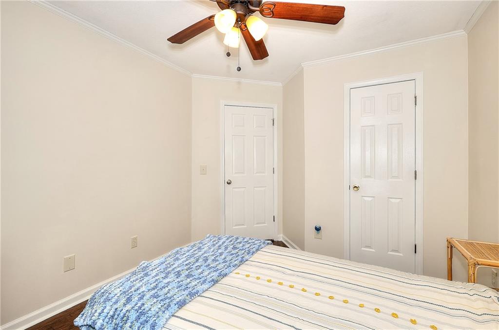 148 Alice Walker Drive Athens, GA 30607 - Photo 21 of 28 a bedroom with a bed and a chandelier